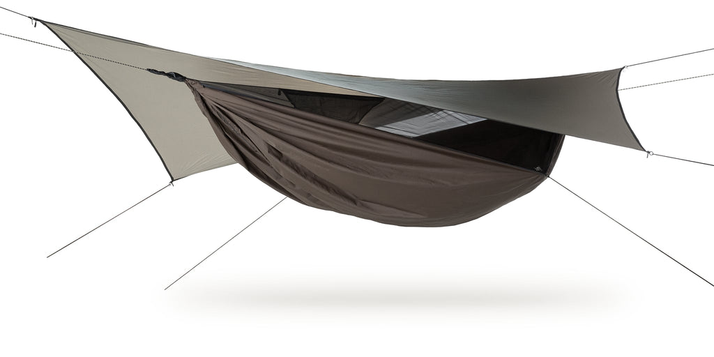 Photo of an Ultralite Backpacker hammock set up against a white background.  The hammock a bark colored.