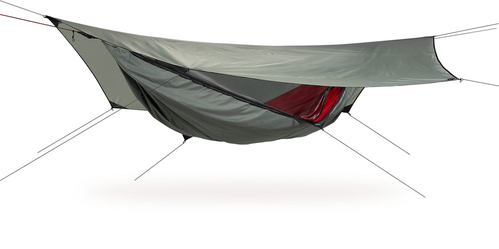 Photo of four season explorer hammock set up against a white background.  The hammock grey with a red interior.