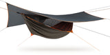 Photo of a four season survivorman hammock set up against a white background.  The hammoick is brown and grey with orange trim and interior.