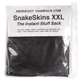 A packaged black fabric hammock insert labeled 'HENNESSY HAMMOCK.COM SnakeSkins XXL The Instant Stuff Sack'.